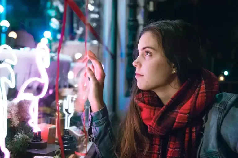 woman-staring-into-Christmas-shop-window